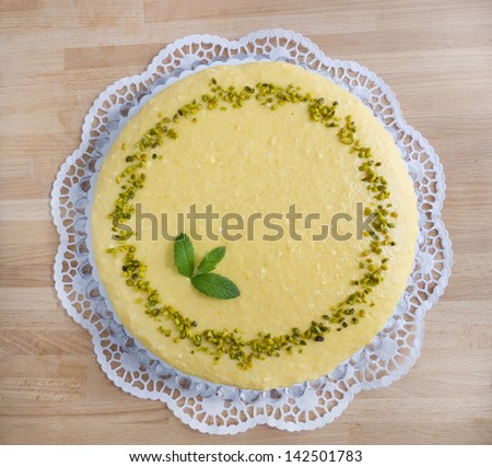 Mango cake with sour cream cake top on wooden board