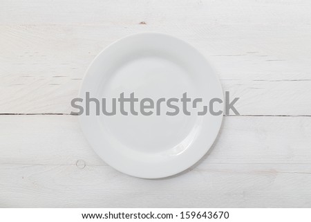 White plate on light wood background