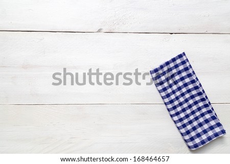 Blue kitchen towel on light wood background