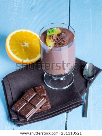 Chocolate pudding dessert with orange and pistachio.