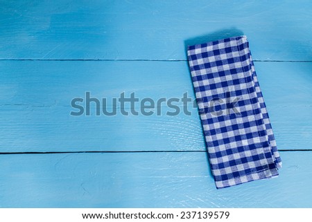 Kitchen towel blue on blue wooden background.