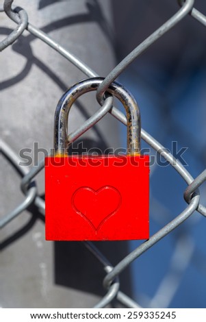Red heart lock with a fence.