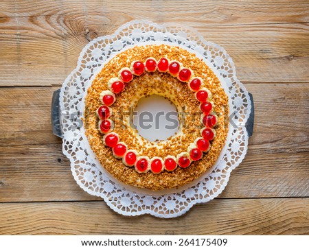Frankfurt crown cake with cherries on rustic wood.