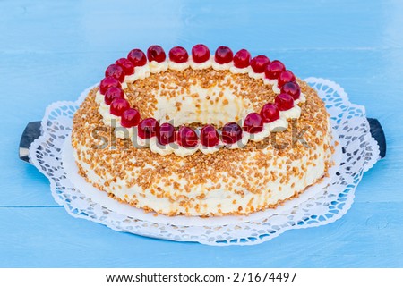 Frankfurt crown cake with cherries on a blue wood