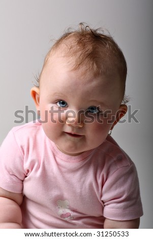 Sweet blue eyed baby girl smiling on fine art portrait