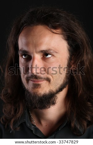 Portrait of guy with long hair and goatee looking up