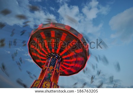 Long exposure of a spinning chain swing ride photographed at the spring beer festival in Munich, Bavaria, Germany