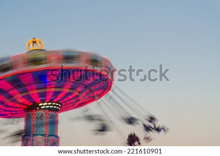 Long exposure of a spinning chain swing ride photographed at Oktoberfest in Munich, Bavaria, Germany