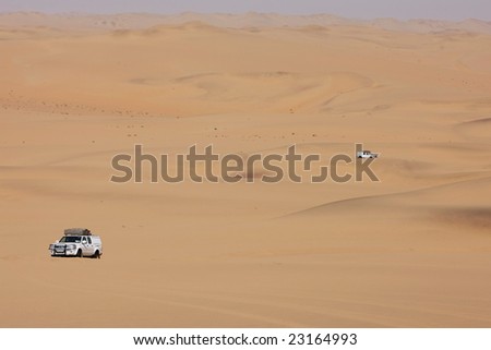 White off-road cars in namibian desert, Africa