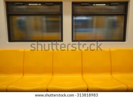 Yellow seats in electric train,There is view from the window. warm tone.