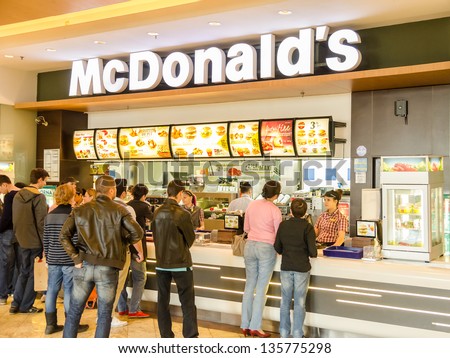 BUCHAREST, ROMANIA - APRIL 12: People buying fast-food from McDonald\'s Restaurant on April 12, 2013 in Bucharest, Romania. McDonald\'s is the main fast-food restaurant chain in Romania.