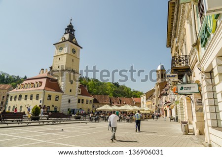 BRASOV, ROMANIA - APRIL 27: Council Square on April 27, 2013 in Brasov, Romania. The Old Town includes the Black Church, Council Square and medieval buildings in different architectural styles.