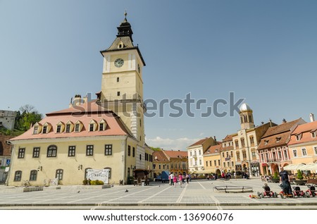 BRASOV, ROMANIA - APRIL 27: Council Square on April 27, 2013 in Brasov, Romania. The Old Town includes the Black Church, Council Square and medieval buildings in different architectural styles.