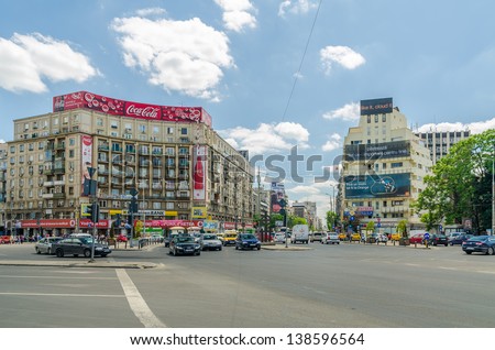 BUCHAREST, ROMANIA - MAY 15: The Roman Square on May 15, 2013 in Bucharest, Romania.  Is a major traffic intersection in downtown Sector 1 and the main building is the Academy of Economic Studies.
