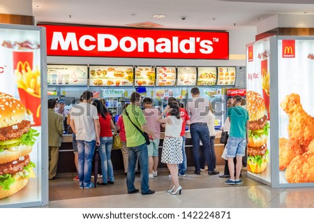 BUCHAREST, ROMANIA - JUNE 13: People buying fast-food from McDonald\'s Restaurant on June 13, 2013 in Bucharest, Romania. McDonald\'s is the main fast-food restaurant chain in Romania.