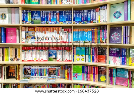 BUCHAREST, ROMANIA - DECEMBER 20, 2013: Travel books in library book stand. Travel literature includes works of exploration as well as guidebooks and accounts of visits to foreign countries.