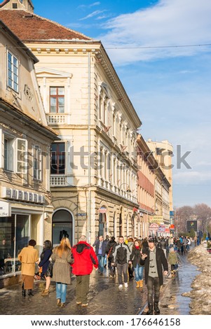 BRASOV, ROMANIA - FEBRUARY 09: Tourists Visiting Historical Old Center on February 09, 2014 in Brasov, Romania. Brasov Is One Of The Main Touristic Cities Of Romania In The Carpathian Mountains.