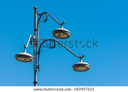 Modern Street Lamp Post On A Blue Sky
