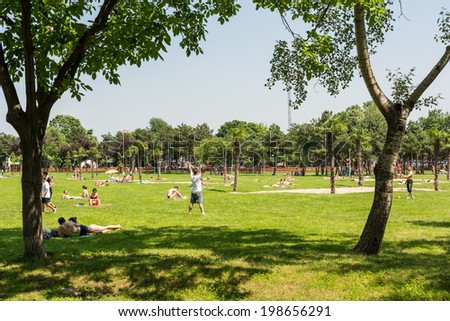 BUCHAREST, ROMANIA - JUNE 08, 2014: People Having Picnic And Playing Games In Public Park On Summer Day.