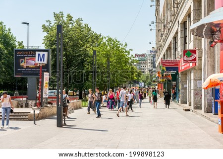 BUCHAREST, ROMANIA - JUNE 09, 2014: Crowd Of Busy People Going To Work In Piata Unirii (Unification Square) Of Bucharest. It is one of the largest squares in central Bucharest.