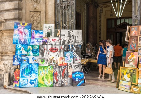 BUCHAREST, ROMANIA - JUNE 29, 2014: Outside Art Gallery Paintings Exposed On Lipscani Street In Downtown Bucharest.