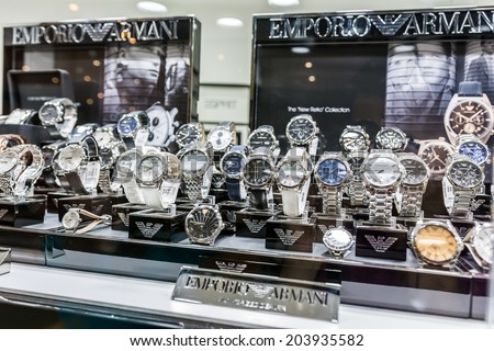 BUCHAREST, ROMANIA - JULY 08, 2014: Giorgio Armani Watches In Shop Window Display. Is an Italian fashion house founded by Giorgio Armani, which designs leather goods, shoes, watches and jewelry.