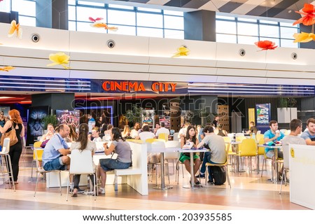 BUCHAREST, ROMANIA - JULY 08: People Eating Fast Food At Movie Theater Cinema Restaurant In Luxurious Shopping Mall on July 08, 2014 In Bucharest, Romania.