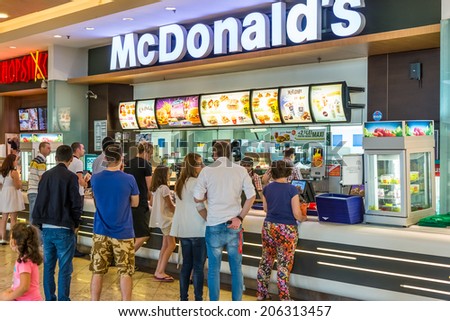 BUCHAREST, ROMANIA - JULY 20, 2014: People buying fast-food from McDonald\'s Restaurant. McDonald\'s is the main fast-food restaurant chain in Romania.