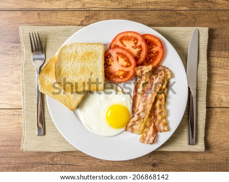 Healthy English Breakfast With Fried Egg, Toast, Bacon And Tomatoes