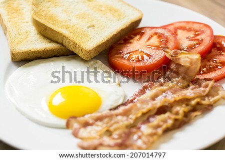 Tasty English Breakfast With Fried Egg, Bacon, Toast And Tomatoes Close Up