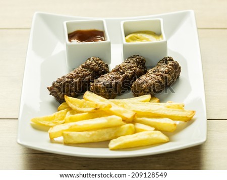 Traditional Romanian Food Meatballs (Mici) And French Fries With Ketchup And Mustard