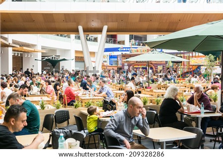 BUCHAREST, ROMANIA - AUGUST 05, 2014: People Eating At Cafe Restaurant In Luxury Shopping Mall Interior.
