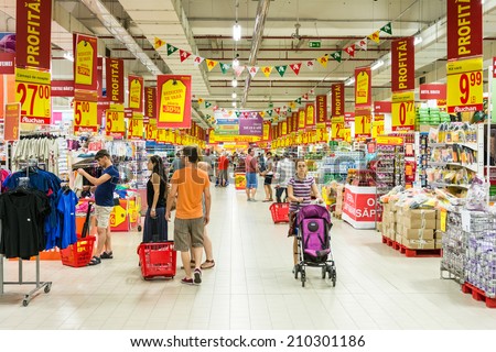 BUCHAREST, ROMANIA - AUGUST 10, 2014: People Shopping In Supermarket Store Aisle.