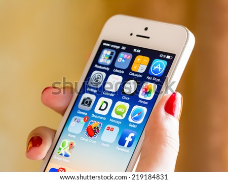 BUCHAREST, ROMANIA - AUGUST 05, 2014: Woman Hand Holding Apple iPhone 5S Smart Phone. It was released on September 20, 2013 and is the high-range phone of the Apple company.