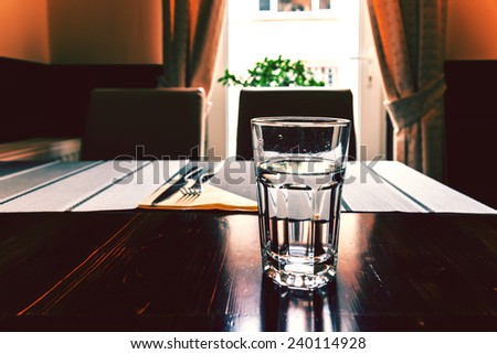 Glass Of Water On Vintage Restaurant Table