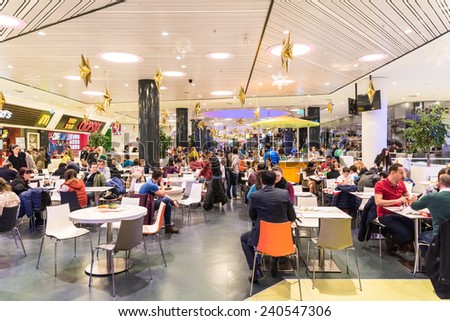 BUCHAREST, ROMANIA - DECEMBER 24, 2014: People Crowd Eating Fast Food On Restaurant Floor In Luxurious Shopping Mall.