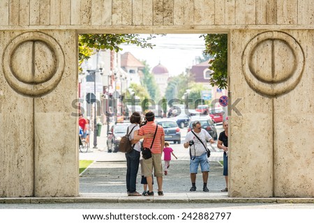 TARGU JIU, ROMANIA - AUGUST 28, 2014: The Gate of the Kiss is a stone sculpture made by Constantin Brancusi in 1938 and symbolizes the triumph of life over death.