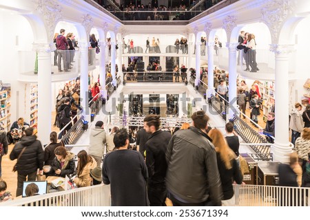 BUCHAREST, ROMANIA - FEBRUARY 13, 2015: People Shopping For Literature Books In Shopping Mall Library.