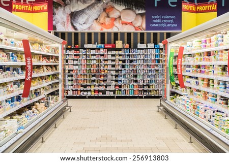 BUCHAREST, ROMANIA - FEBRUARY 25, 2015: Supermarket Food In Refrigerators On Store Aisle.