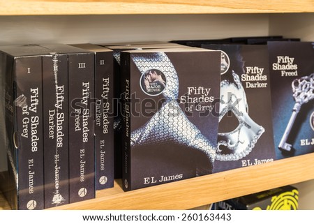 BUCHAREST, ROMANIA - MARCH 12, 2015: Fifty Shades of Grey Bestseller Books For Sale On Library Shelf. Written in 2011 it is an erotic romance novel and was sold in over 100 million copies worldwide.