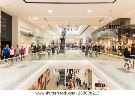 BUCHAREST, ROMANIA - JUNE 01, 2015: People Crowd Shopping In Luxury Mall Interior.