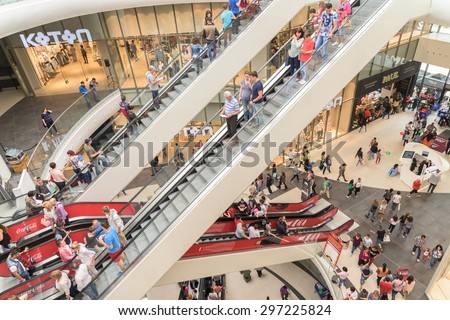 BUCHAREST, ROMANIA - JULY 16, 2015: People Crowd Rush In Shopping Luxury Mall Interior.