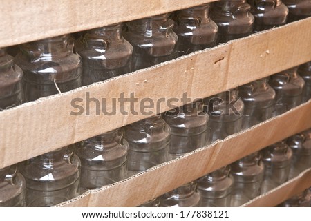 ?Bottles, empty glass bottles in rows stacked in paper box, bottle industry, bottles in box