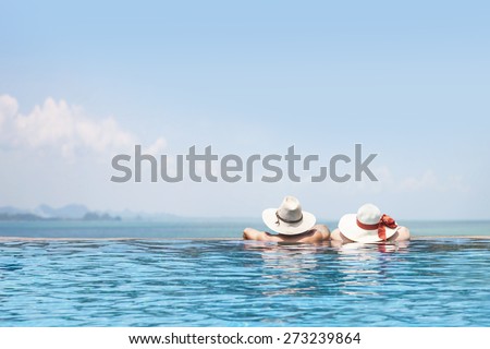 male and female models in the swimming pool wearing hats facing to the sea, beautiful summer vacation poster background, happy tour, enjoy travel, tourism, fun trip