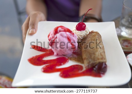 red cherry and weep cream served with ice cream and pancake on white plate