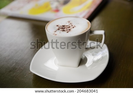 cup of cappuccino in a white cup on table