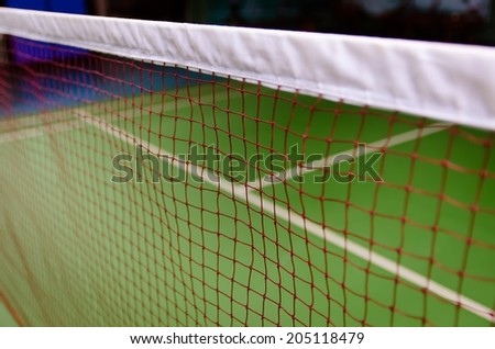 net and green floor badminton court