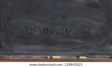 Blank blackboard with colored chalks