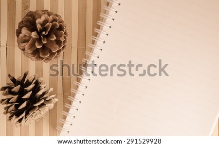 blank spiral notepad notebook with pencil on brown bamboo background