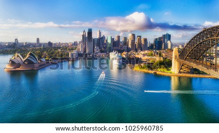 Major architecture landmarks of the city of Sydney and Australia around Sydney harbour in elevated aerial view in warm smooth sunlight at the morning.